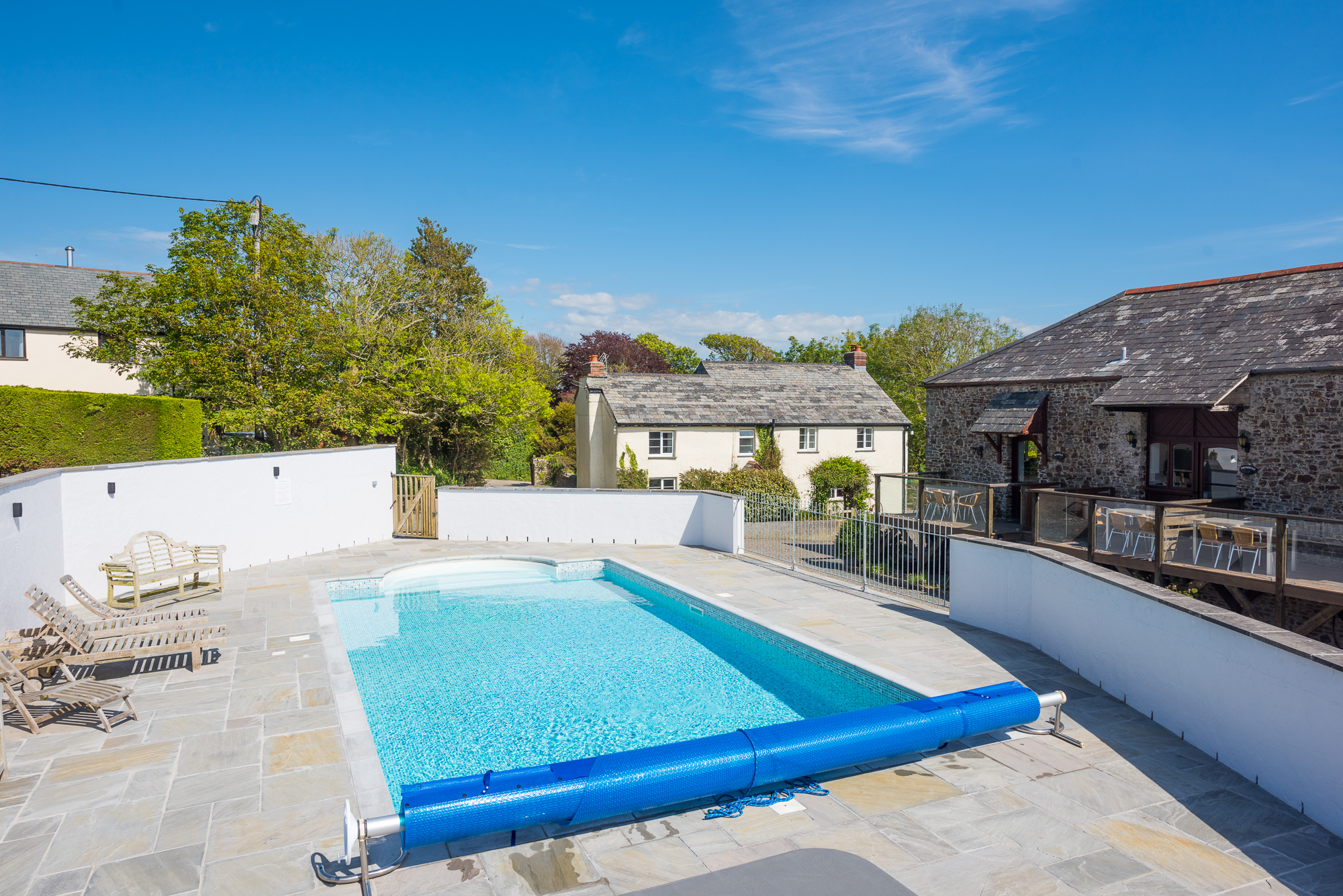 Outdoor heated pool with the Farmhouse in the background.